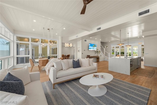 15009 Binder Dr, Captiva, FL 33924 - living room featuring light wood-style flooring, stairway, a chandelier, recessed lighting, and wood ceiling with exposed beams