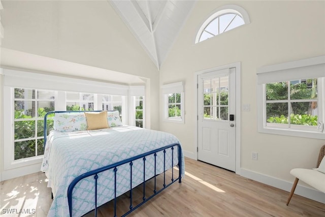 15009 Binder Dr, Captiva, FL 33924 - bedroom featuring high vaulted ceiling, baseboards, and light wood finished floors