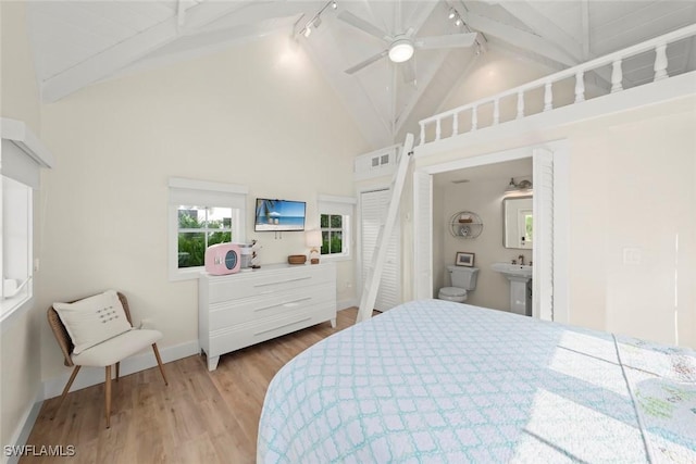 15009 Binder Dr, Captiva, FL 33924 - bedroom with track lighting, wood finished floors, beamed ceiling, high vaulted ceiling, and baseboards