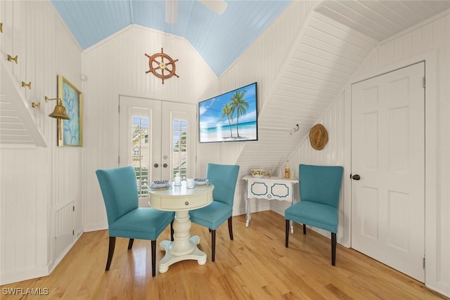 15009 Binder Dr, Captiva, FL 33924 - dining area featuring lofted ceiling, wood finished floors, wooden walls, and french doors