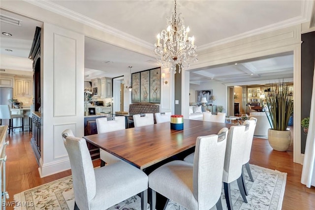 1920 Virginia Ave Unit 1602, Fort Myers, FL 33901 - dining room featuring light wood-style floors, ornamental molding, a chandelier, beam ceiling, and coffered ceiling