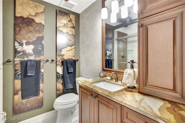 1920 Virginia Ave Unit 1602, Fort Myers, FL 33901 - bathroom featuring tile walls, toilet, vanity, a shower stall, and tile patterned flooring
