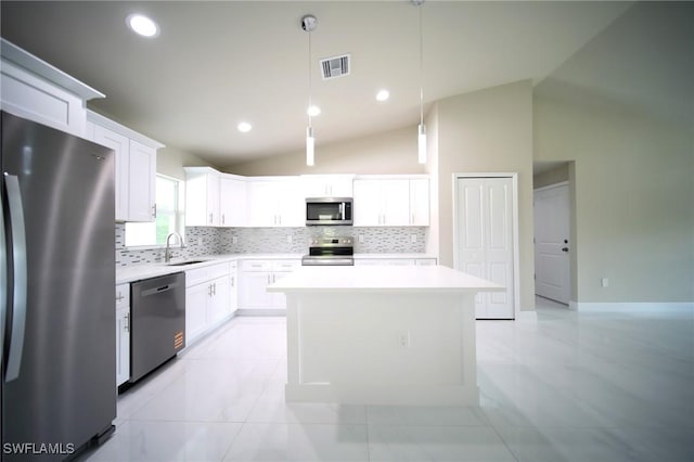 1893 Weldon Ave, Lehigh Acres, FL 33972 - kitchen with appliances with stainless steel finishes, vaulted ceiling, tasteful backsplash, light countertops, and white cabinetry
