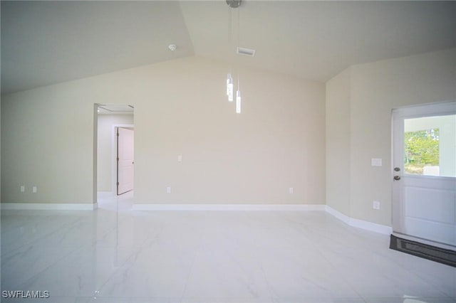 1893 Weldon Ave, Lehigh Acres, FL 33972 - empty room with vaulted ceiling, light marble finish floors, baseboards, and attic access