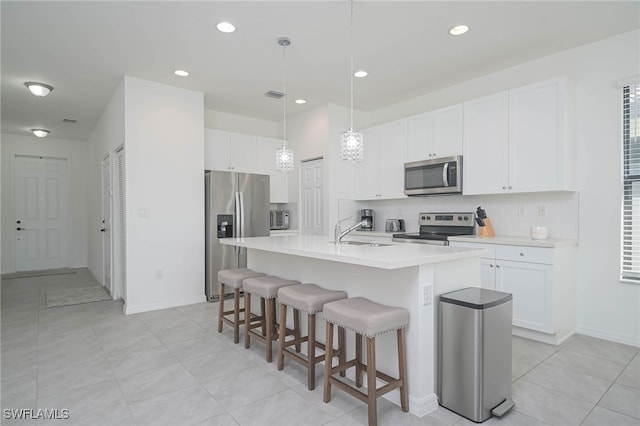 5536 Morino Way, Ave Maria, FL 34142 - kitchen with stainless steel appliances, a sink, decorative backsplash, a kitchen breakfast bar, and recessed lighting