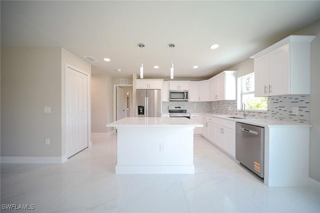 1895 Weldon Ave, Lehigh Acres, FL 33972 - kitchen with stainless steel appliances, a sink, decorative backsplash, white cabinets, and recessed lighting