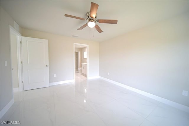 1895 Weldon Ave, Lehigh Acres, FL 33972 - unfurnished room with baseboards, a ceiling fan, and light marble finish flooring