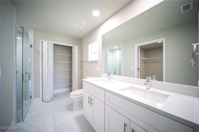 1895 Weldon Ave, Lehigh Acres, FL 33972 - full bathroom with a spacious closet, double vanity, a shower stall, toilet, and recessed lighting