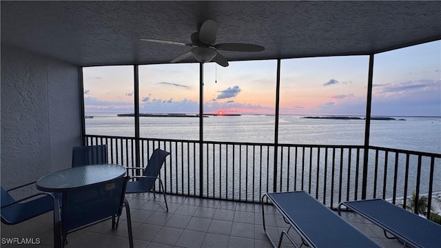17170 Harbour Point Dr Unit 736, Fort Myers, FL 33908 - sunroom with a water view, a textured wall, tile patterned floors, and a textured ceiling