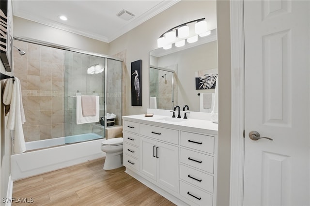 28657 San Lucas Ln Unit 102, Bonita Springs, FL 34135 - bathroom featuring vanity, ornamental molding, combined bath / shower with glass door, wood finished floors, and recessed lighting