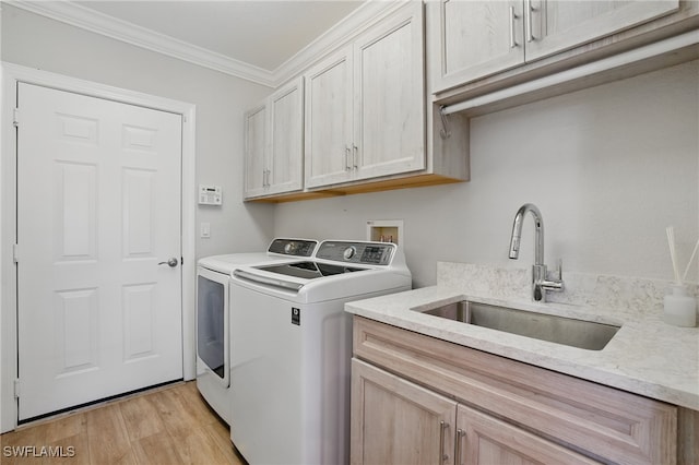 28657 San Lucas Ln Unit 102, Bonita Springs, FL 34135 - washroom with independent washer and dryer, cabinet space, crown molding, and light wood-style flooring