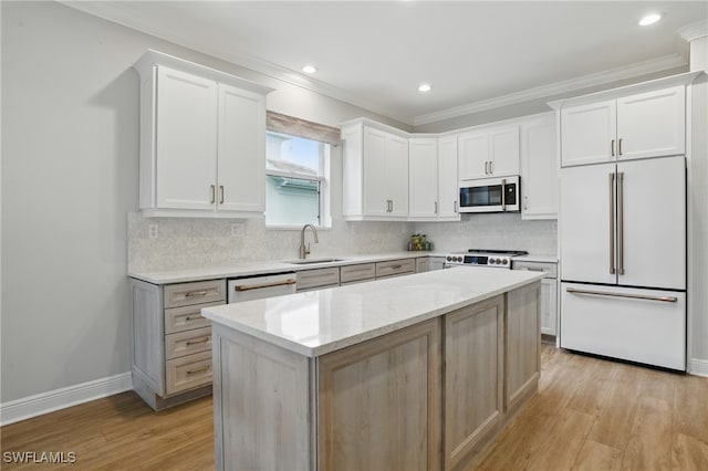 28657 San Lucas Ln Unit 102, Bonita Springs, FL 34135 - kitchen with white appliances, crown molding, light wood-type flooring, tasteful backsplash, and a center island