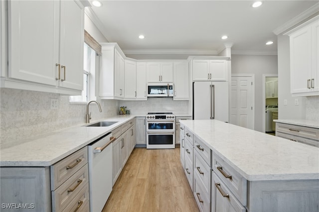 28657 San Lucas Ln Unit 102, Bonita Springs, FL 34135 - kitchen with high quality appliances, ornamental molding, a kitchen island, light wood-type flooring, and backsplash