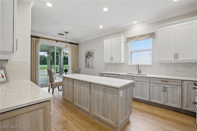 28657 San Lucas Ln Unit 102, Bonita Springs, FL 34135 - kitchen featuring a center island, ornamental molding, tasteful backsplash, recessed lighting, and pendant lighting