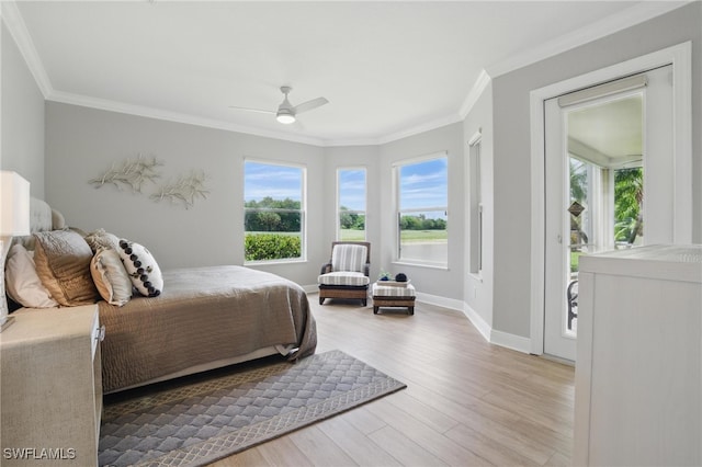28657 San Lucas Ln Unit 102, Bonita Springs, FL 34135 - bedroom featuring multiple windows, crown molding, wood finished floors, and ceiling fan