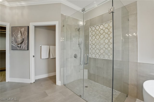 28657 San Lucas Ln Unit 102, Bonita Springs, FL 34135 - full bathroom featuring a shower stall, a freestanding tub, crown molding, a spacious closet, and tile patterned floors