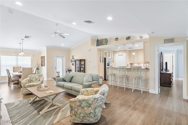 2608 NW 25th Ave, Cape Coral, FL 33993 - living room with vaulted ceiling, crown molding, light wood-style flooring, a ceiling fan, and baseboards