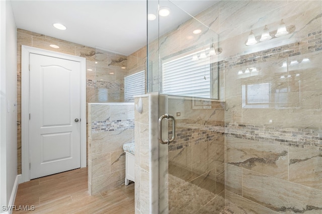 2608 NW 25th Ave, Cape Coral, FL 33993 - bathroom with a shower stall, wood finished floors, and tile walls