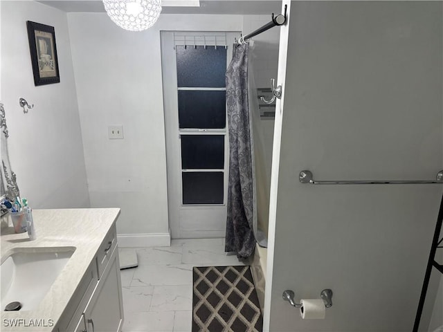 5504 Brookfield St, Lehigh Acres, FL 33971 - bathroom featuring marble finish floors, vanity, and baseboards