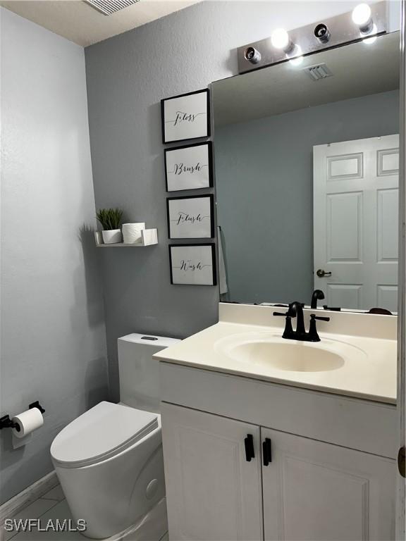 1839 Jovita Ave, Lehigh Acres, FL 33972 - half bathroom featuring toilet and vanity