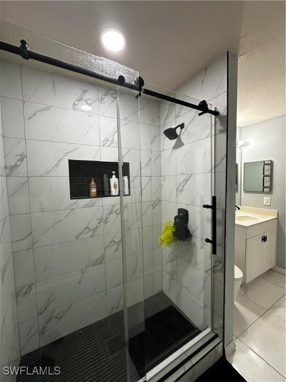 1839 Jovita Ave, Lehigh Acres, FL 33972 - full bath with vanity, a stall shower, and marble finish flooring