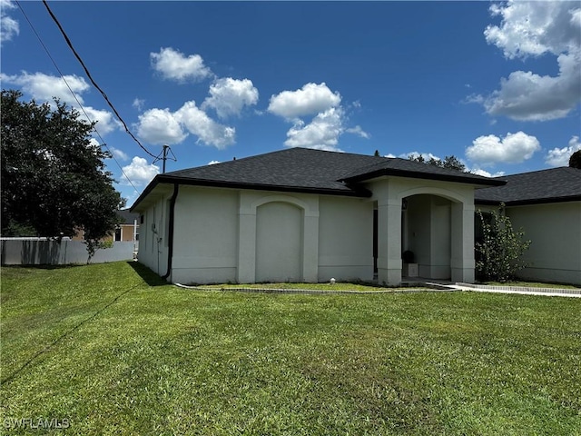 1839 Jovita Ave, Lehigh Acres, FL 33972 - rear view of house with stucco siding and a shingled roof