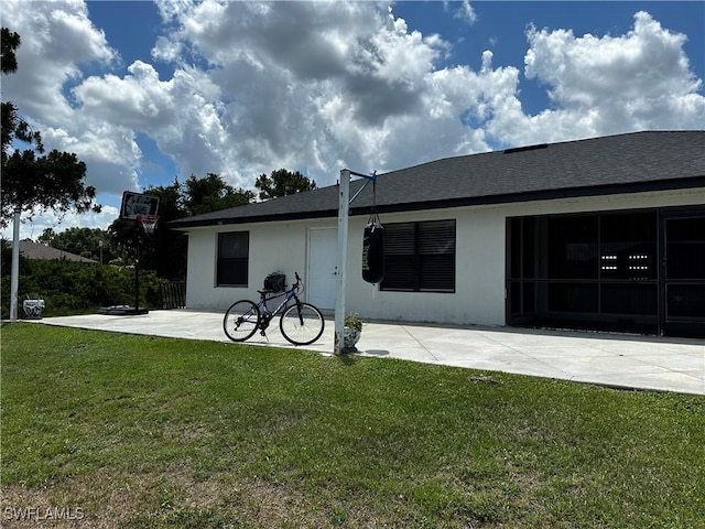 1839 Jovita Ave, Lehigh Acres, FL 33972 - back of property with a yard, stucco siding, a patio, and a shingled roof