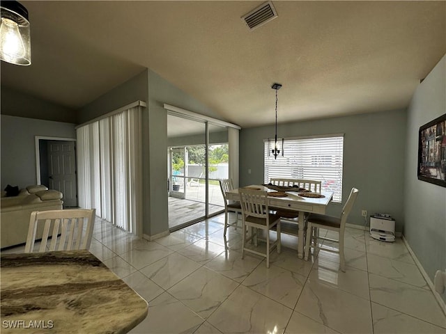 1839 Jovita Ave, Lehigh Acres, FL 33972 - dining area with light marble finish flooring, a chandelier, vaulted ceiling, and baseboards