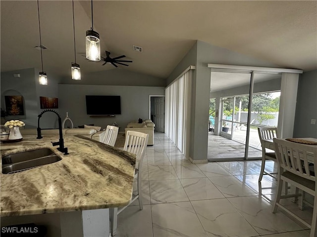 1839 Jovita Ave, Lehigh Acres, FL 33972 - kitchen featuring a sink, light marble finish flooring, vaulted ceiling, light stone counters, and hanging light fixtures
