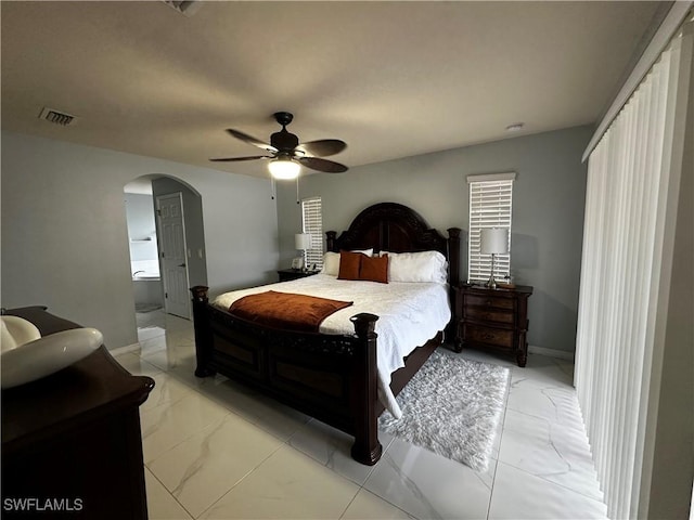 1839 Jovita Ave, Lehigh Acres, FL 33972 - bedroom featuring arched walkways, baseboards, ceiling fan, and light marble finish floors