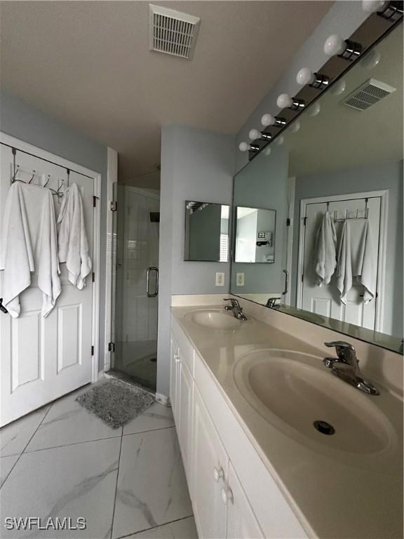 1839 Jovita Ave, Lehigh Acres, FL 33972 - bathroom with double vanity, a shower stall, and marble look tile flooring