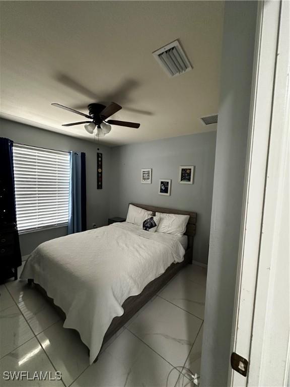 1839 Jovita Ave, Lehigh Acres, FL 33972 - bedroom featuring light marble finish flooring and ceiling fan