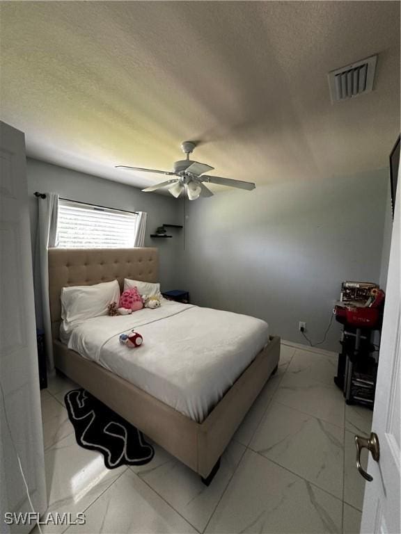 1839 Jovita Ave, Lehigh Acres, FL 33972 - bedroom with light marble finish flooring, a textured ceiling, and a ceiling fan