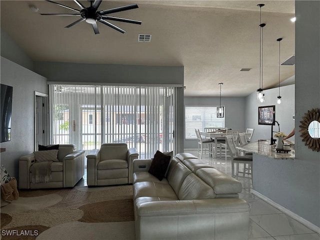 1839 Jovita Ave, Lehigh Acres, FL 33972 - living area with a ceiling fan, baseboards, and marble look tile flooring
