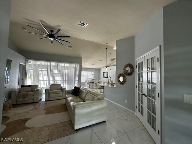 1839 Jovita Ave, Lehigh Acres, FL 33972 - living room with marble finish flooring, french doors, ceiling fan, and baseboards