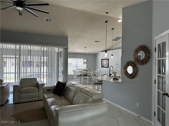 1839 Jovita Ave, Lehigh Acres, FL 33972 - living room featuring a ceiling fan, baseboards, and a textured ceiling