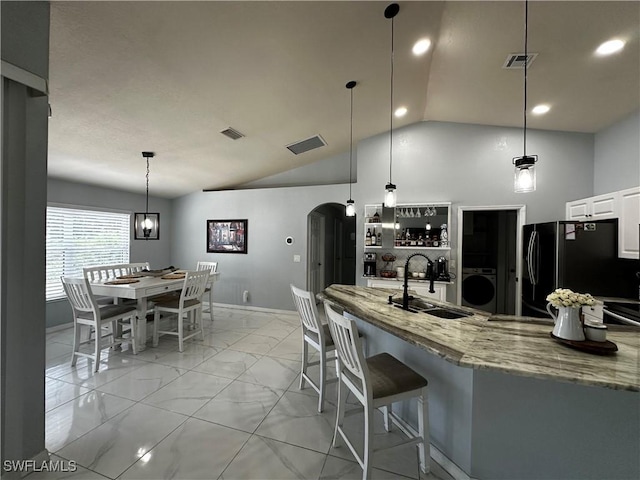 1839 Jovita Ave, Lehigh Acres, FL 33972 - kitchen with a sink, washer / dryer, light marble finish floors, lofted ceiling, and baseboards