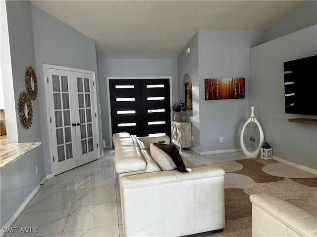 1839 Jovita Ave, Lehigh Acres, FL 33972 - living area featuring french doors, arched walkways, light marble finish flooring, and baseboards