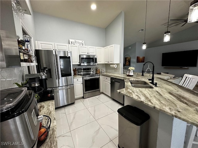 1839 Jovita Ave, Lehigh Acres, FL 33972 - kitchen featuring stainless steel appliances, a sink, a peninsula, light stone countertops, and light marble finish flooring