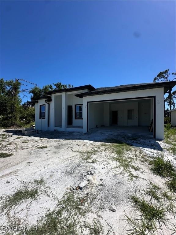 205 Australian Dr, Rotonda West, FL 33947 - view of front of property with a garage and stucco siding
