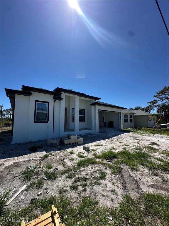 205 Australian Dr, Rotonda West, FL 33947 - view of front of property featuring a garage and stucco siding