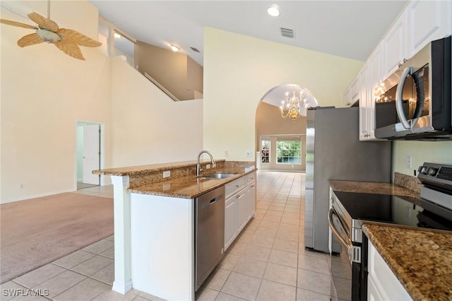 25941 Pebblecreek Dr, Bonita Springs, FL 34135 - kitchen with stainless steel appliances, a high ceiling, a sink, light colored carpet, and light tile patterned floors