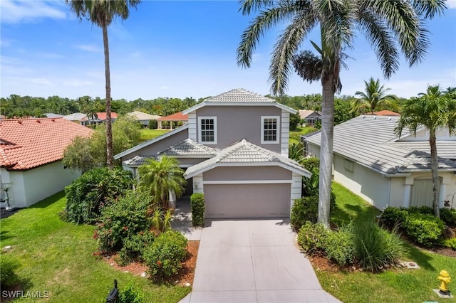 25941 Pebblecreek Dr, Bonita Springs, FL 34135 - view of front facade featuring driveway, stucco siding, an attached garage, a front yard, and a tile roof