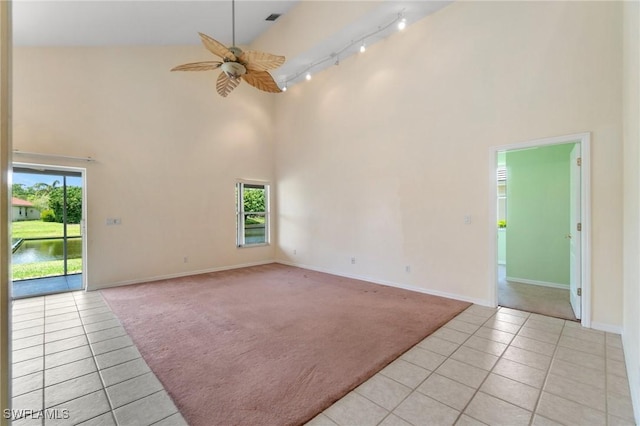 25941 Pebblecreek Dr, Bonita Springs, FL 34135 - empty room featuring high vaulted ceiling, track lighting, light tile patterned floors, light carpet, and ceiling fan