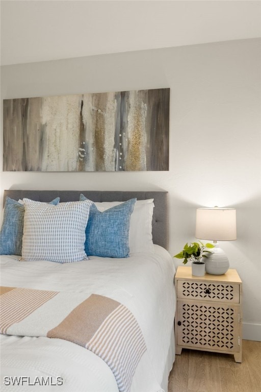 6142 Whiskey Creek Dr Unit 628, Fort Myers, FL 33919 - bedroom featuring wood finished floors and baseboards