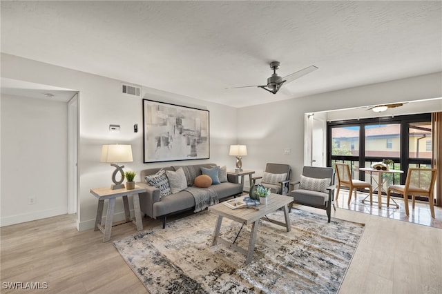 6142 Whiskey Creek Dr Unit 628, Fort Myers, FL 33919 - living area with wood finished floors, ceiling fan, and baseboards