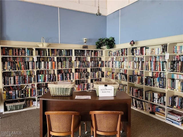 6142 Whiskey Creek Dr Unit 628, Fort Myers, FL 33919 - home office with wall of books and carpet