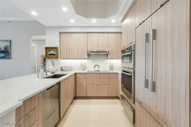 2728 Tiburon Blvd E Unit A403, Naples, FL 34109 - kitchen featuring a sink, modern cabinets, stainless steel appliances, light brown cabinetry, and under cabinet range hood