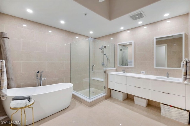 2728 Tiburon Blvd E Unit A403, Naples, FL 34109 - full bath featuring tile walls, a stall shower, a freestanding tub, double vanity, and recessed lighting