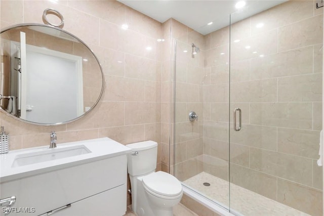 2728 Tiburon Blvd E Unit A403, Naples, FL 34109 - full bathroom with a shower stall, vanity, tile walls, and toilet